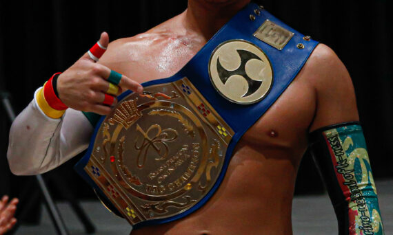 U-T shows off his tag team title belt