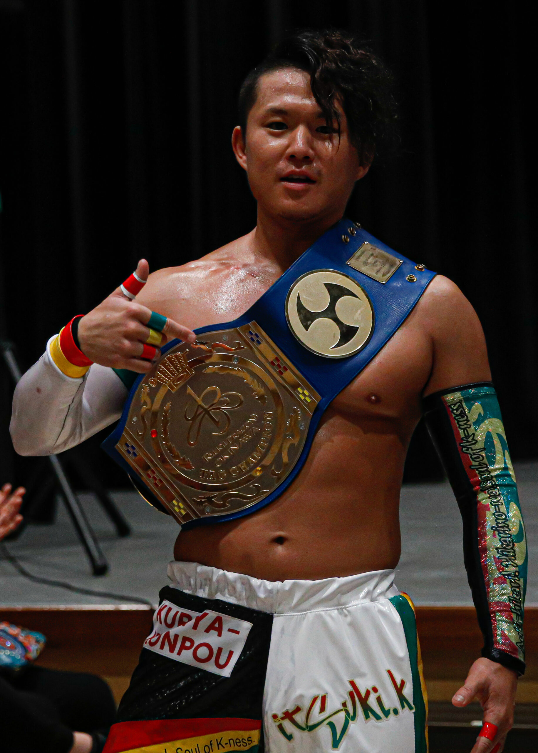 U-T shows off his tag team title belt