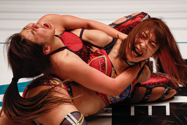 Hazuki attempts to submit Momo Kohgo in trios action