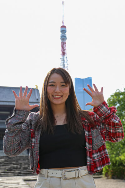 Sareee poses, raising both hands