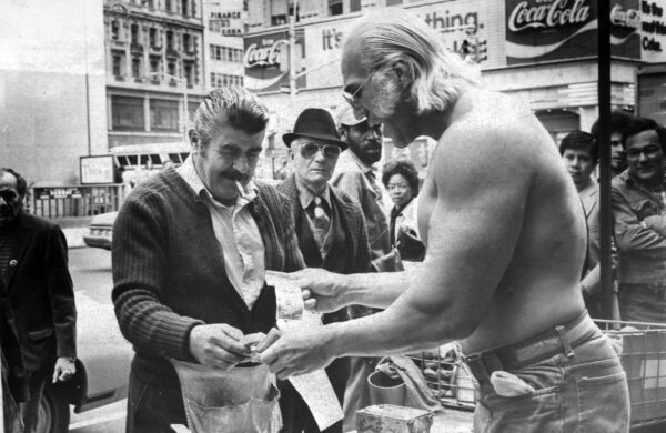 Superstar Graham pays for food from a NYC street vendor, photographed by Bill Apter