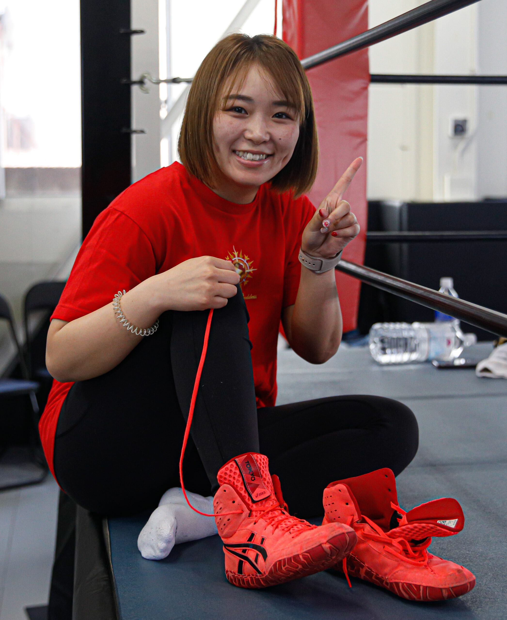 Saree sits on the ring apron and smiles at the camera