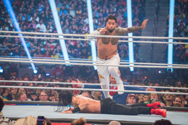 Jey Uso leaps over Roman Reigns during their main-event match at SummerSlam